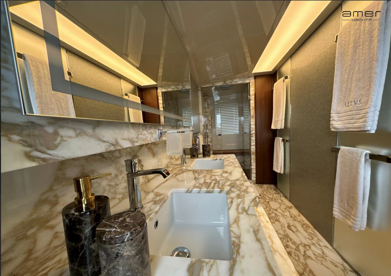 The bathroom features luxurious marble countertops and modern fixtures, creating an elegant and serene atmosphere. aboard ALTUS Yacht for Sale