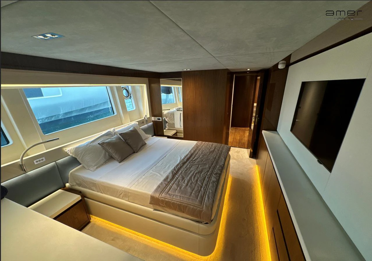 The master stateroom features a luxurious bed with ambient lighting and modern decor. aboard ALTUS Yacht for Sale