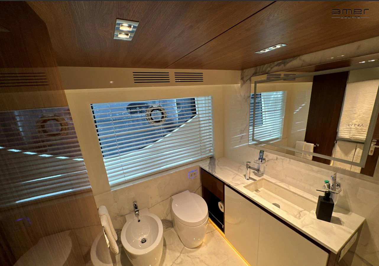 The bathroom features modern fixtures with a sleek design and ample lighting. aboard ALTUS Yacht for Sale