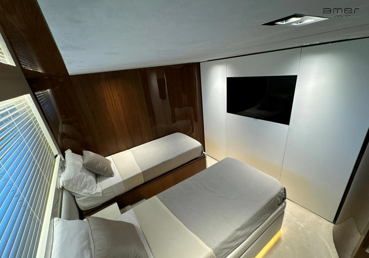 The guest stateroom features two single beds with modern decor and a sleek design. aboard ALTUS Yacht for Sale