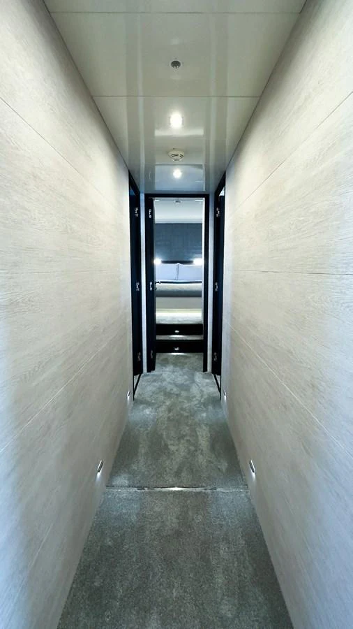 A sleek and modern hallway leading to a stateroom. aboard DEEA II Yacht for Sale