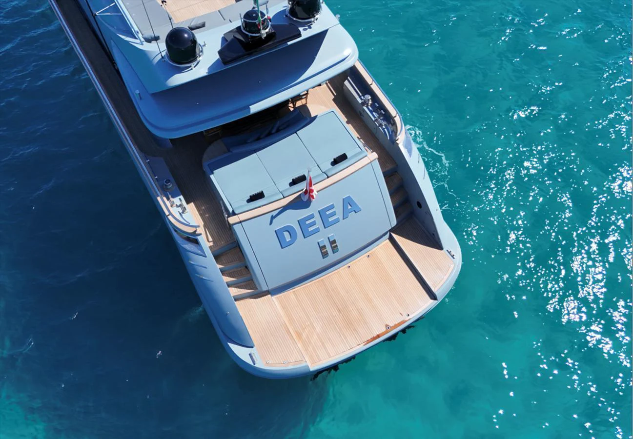 The yacht's aft deck is showcased against a stunning turquoise sea. aboard DEEA II Yacht for Sale