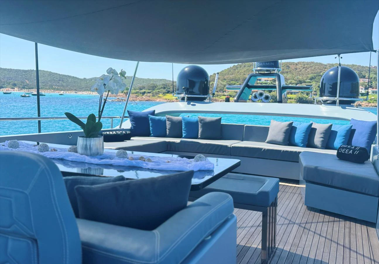 The aft deck offers a spacious and shaded lounging area with comfortable seating and scenic views. aboard DEEA II Yacht for Sale