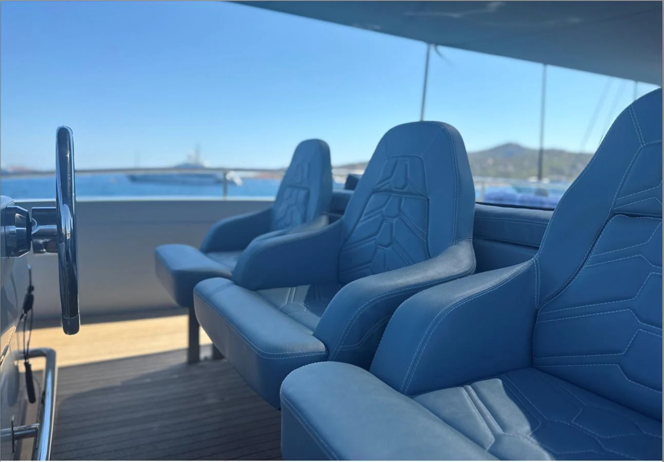 The helm features comfortable, modern seating with a view of the sea. aboard DEEA II Yacht for Sale