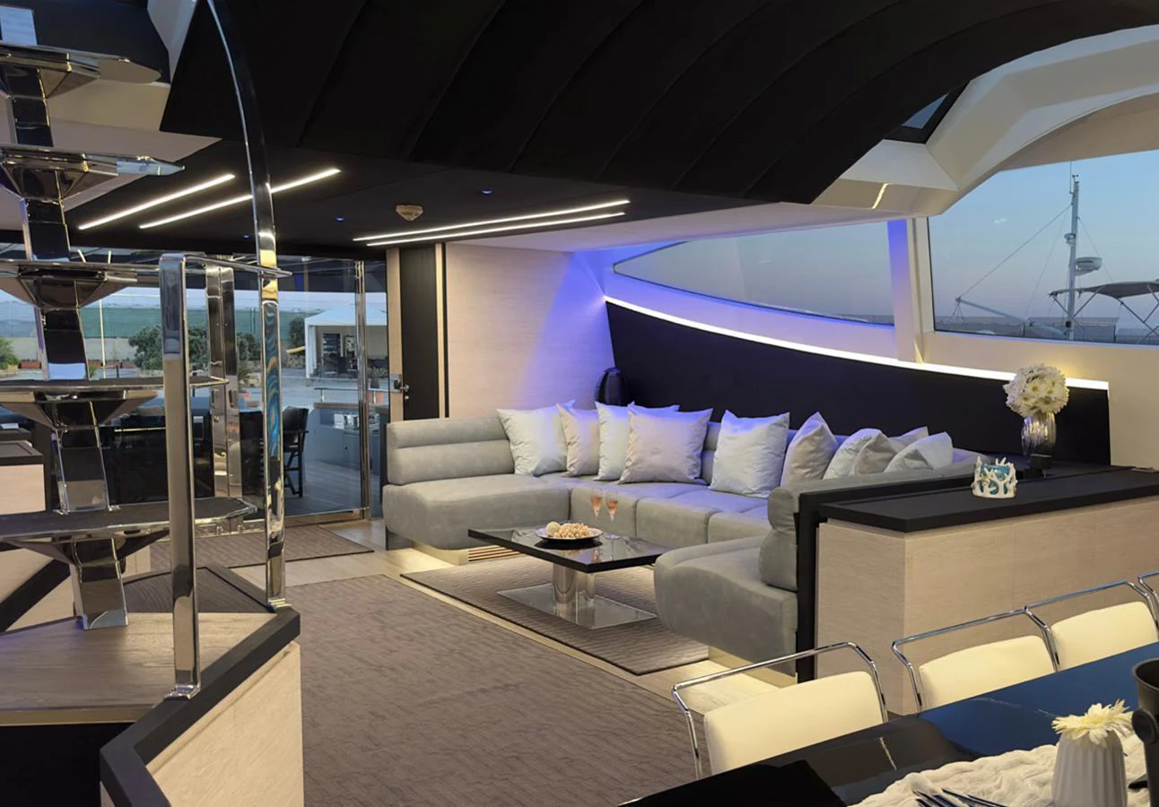 The yacht's salon features a modern and luxurious seating area with ample natural light and elegant decor. aboard DEEA II Yacht for Sale