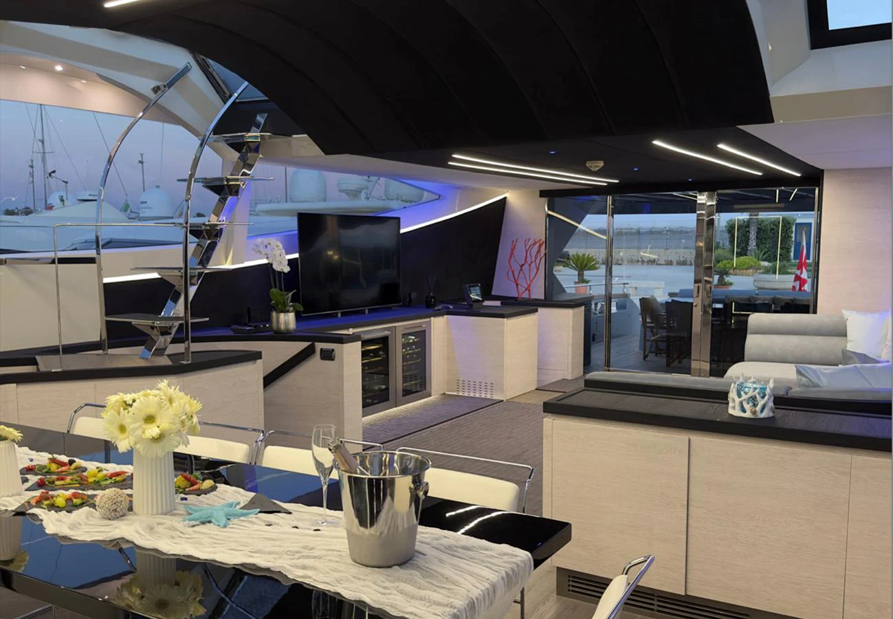 The modern salon features sleek furnishings and ample natural light, creating a luxurious and inviting atmosphere. aboard DEEA II Yacht for Sale