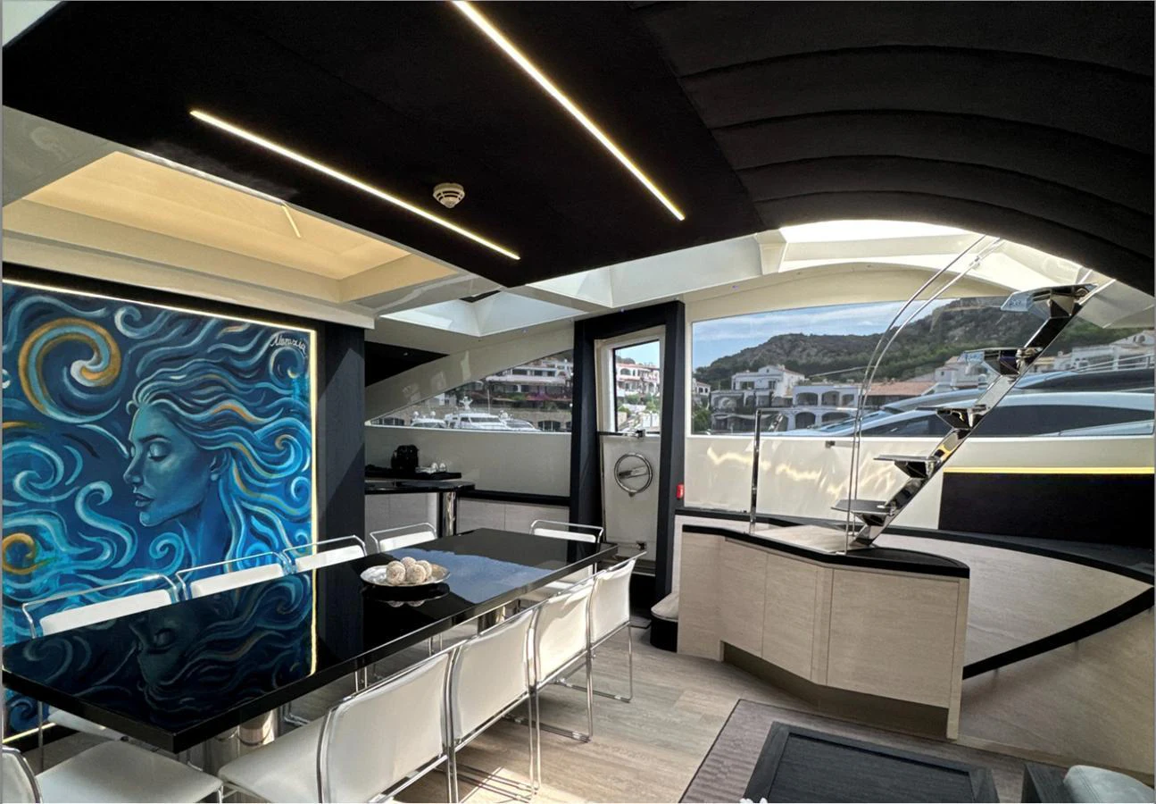 The yacht's dining area features a sleek, modern design with ample natural light and stylish decor. aboard DEEA II Yacht for Sale
