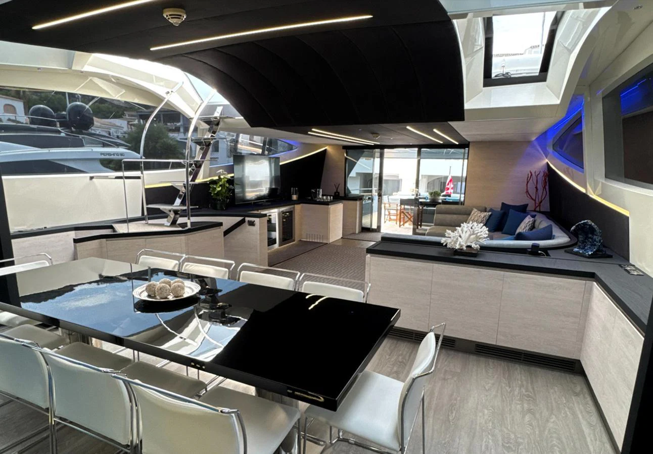 The yacht's interior dining area features a sleek, modern design with ample seating and natural light. aboard DEEA II Yacht for Sale