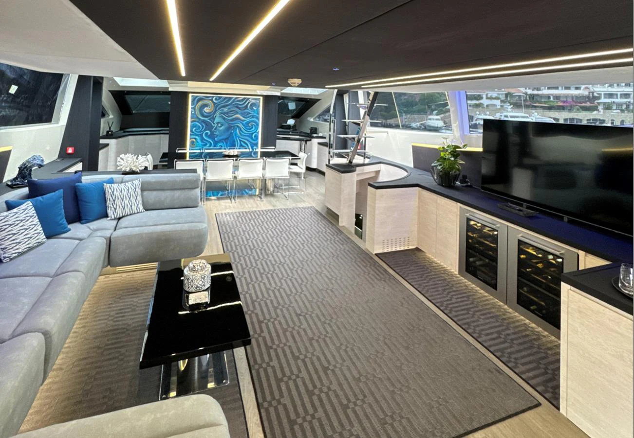 The yacht's salon features modern furnishings with ample seating and a large flat-screen TV, creating a luxurious and comfortable living space. aboard DEEA II Yacht for Sale