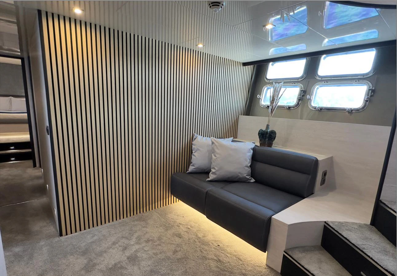 The yacht's interior features a cozy seating area with modern design elements and ample natural light. aboard DEEA II Yacht for Sale