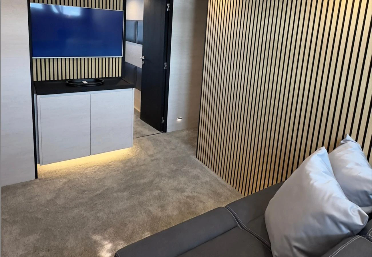 The yacht's interior features a cozy lounge area with a modern entertainment setup. aboard DEEA II Yacht for Sale