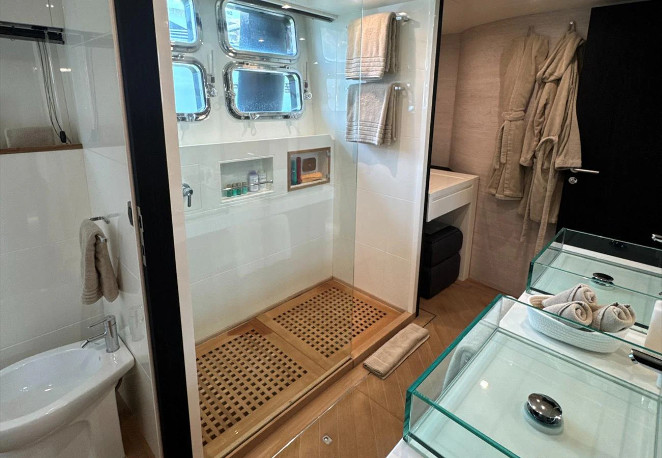 The yacht's bathroom features modern fixtures and a spacious shower area with ample natural light. aboard DEEA II Yacht for Sale