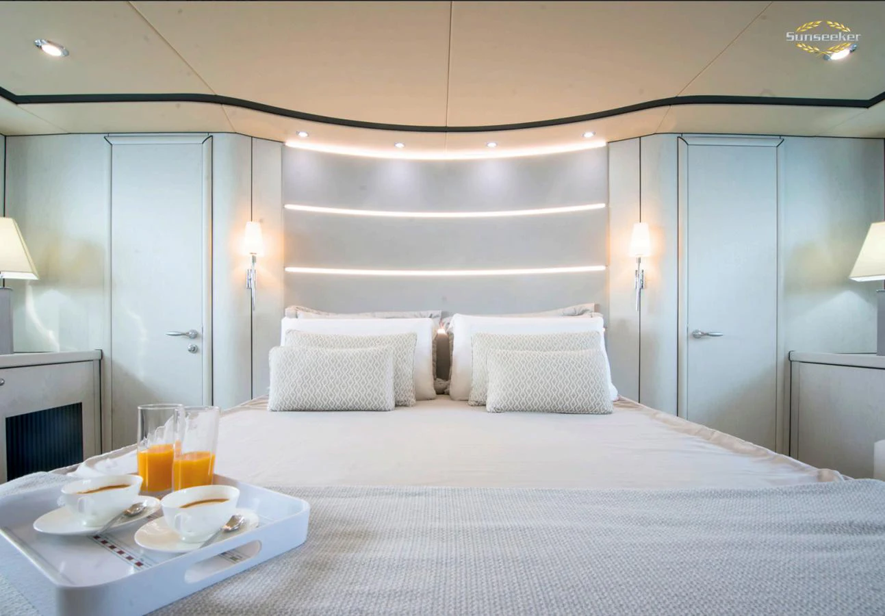 a bed with a tray of food and drinks on it aboard LIGHT BLUE Yacht for Sale