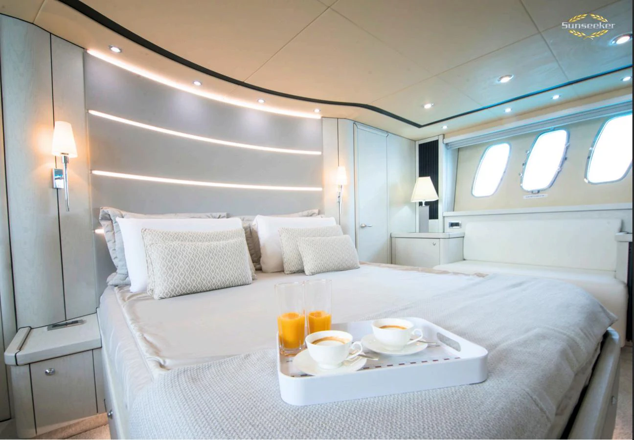 a bed with white sheets and pillows aboard LIGHT BLUE Yacht for Sale