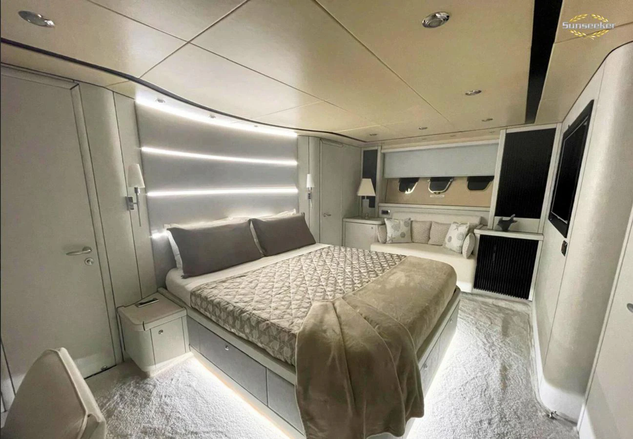 a room with a bed and a tv aboard LIGHT BLUE Yacht for Sale