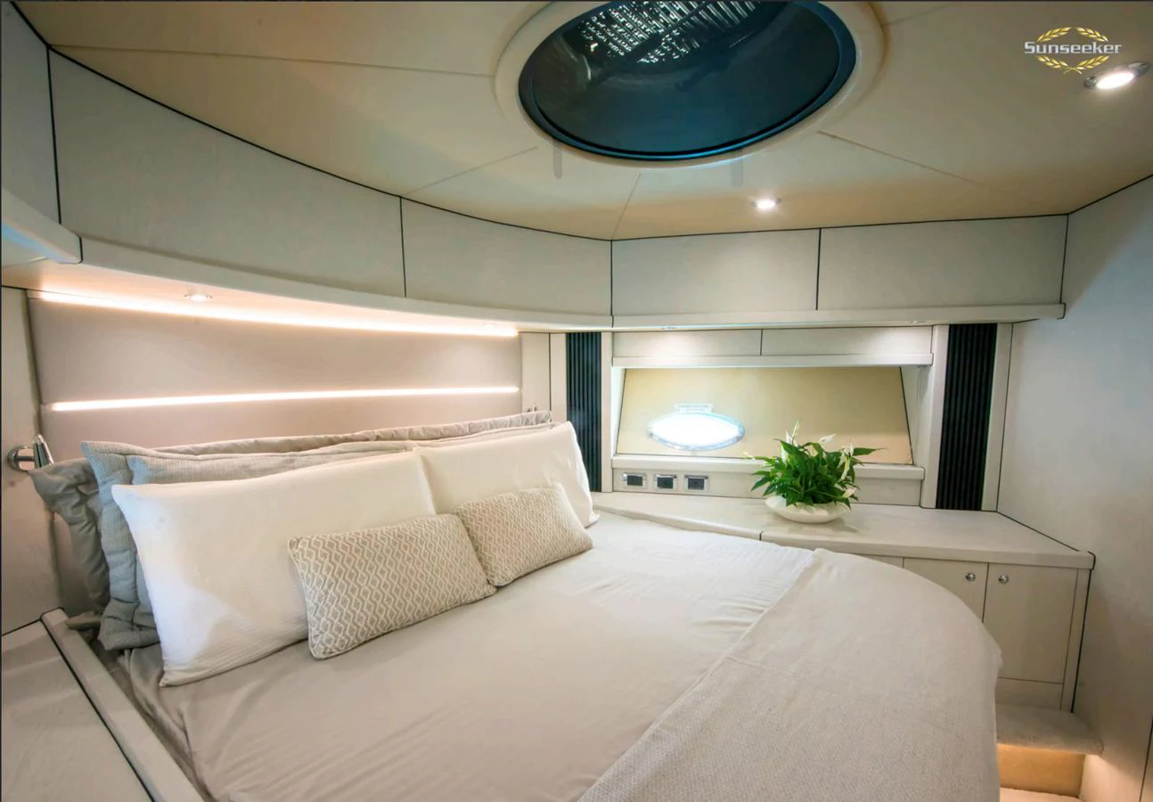 a white bedroom with a large bed aboard LIGHT BLUE Yacht for Sale