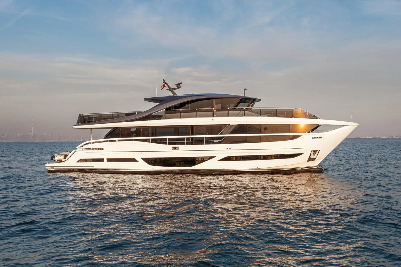 A sleek, modern yacht cruising on calm waters under a clear sky. aboard PRINCESS X95 808 Yacht for Sale