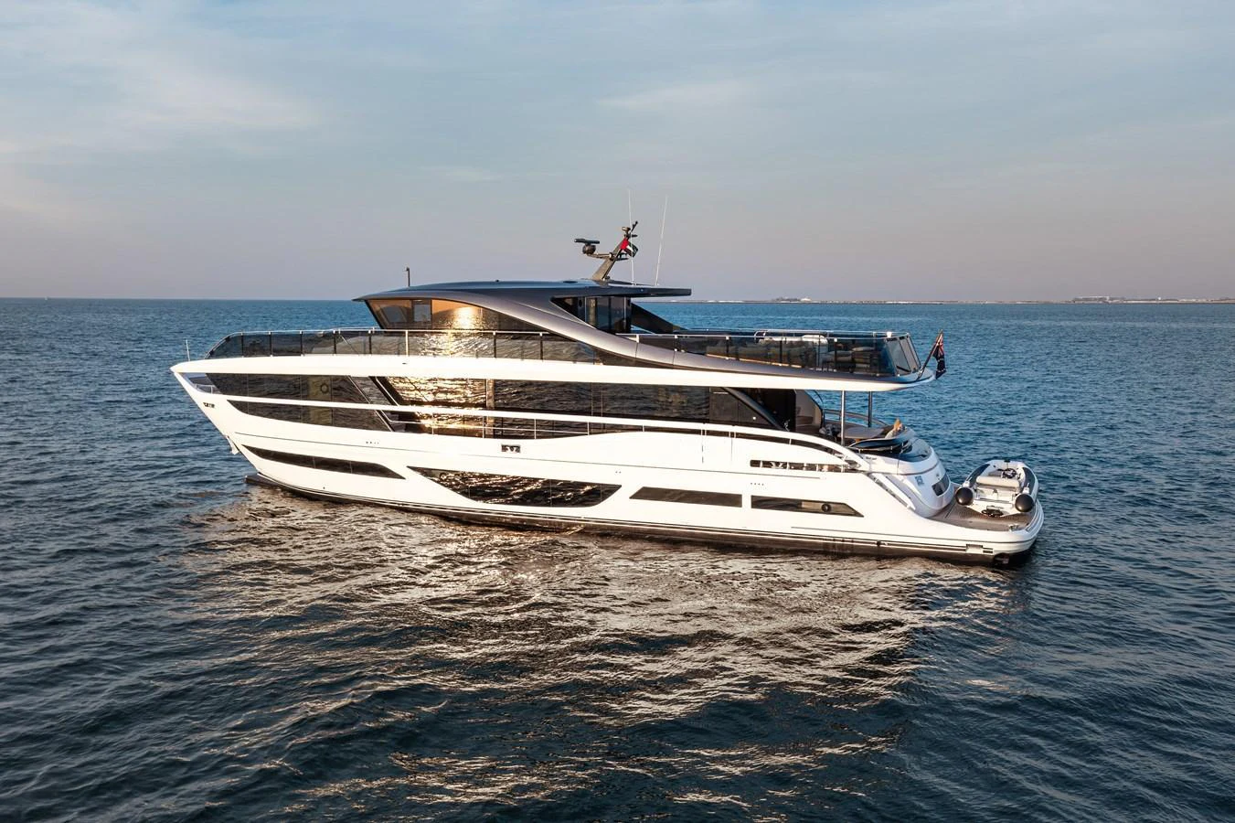 A sleek and modern yacht glides gracefully on calm waters under a clear sky. aboard PRINCESS X95 808 Yacht for Sale
