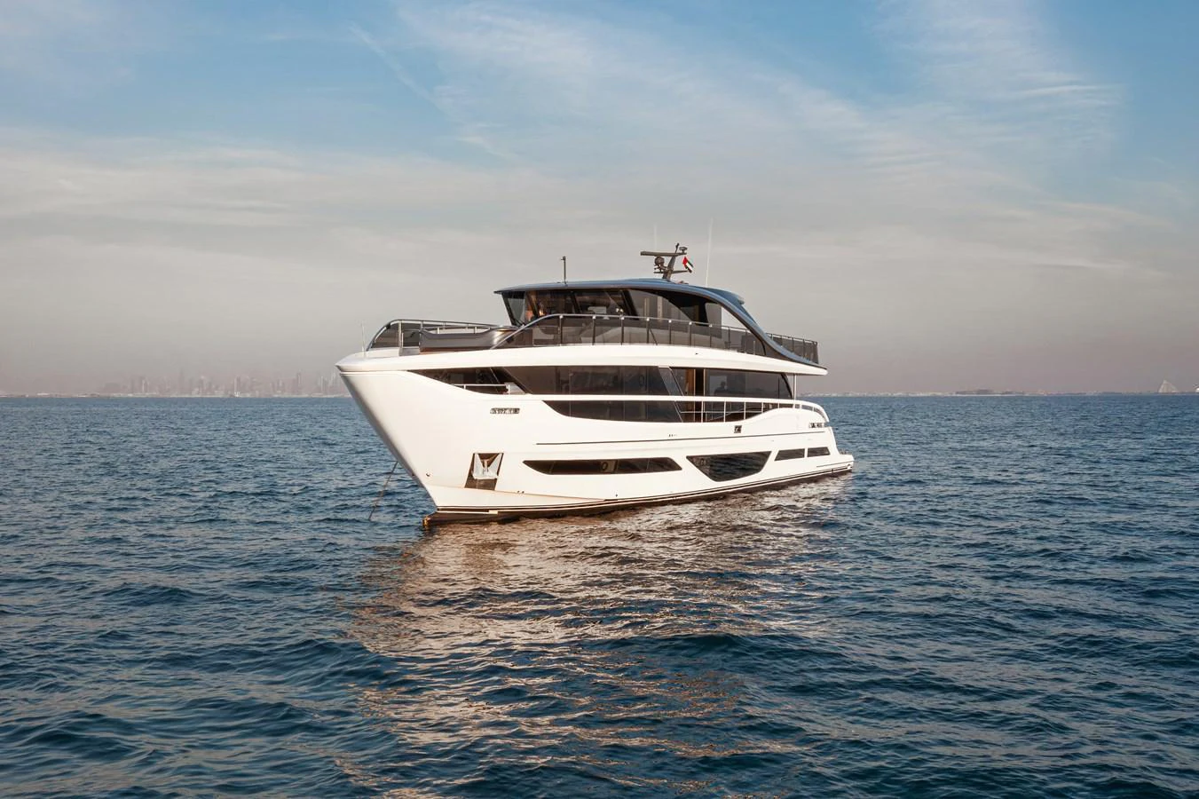 A sleek and modern yacht cruising on calm waters under a clear sky. aboard PRINCESS X95 808 Yacht for Sale
