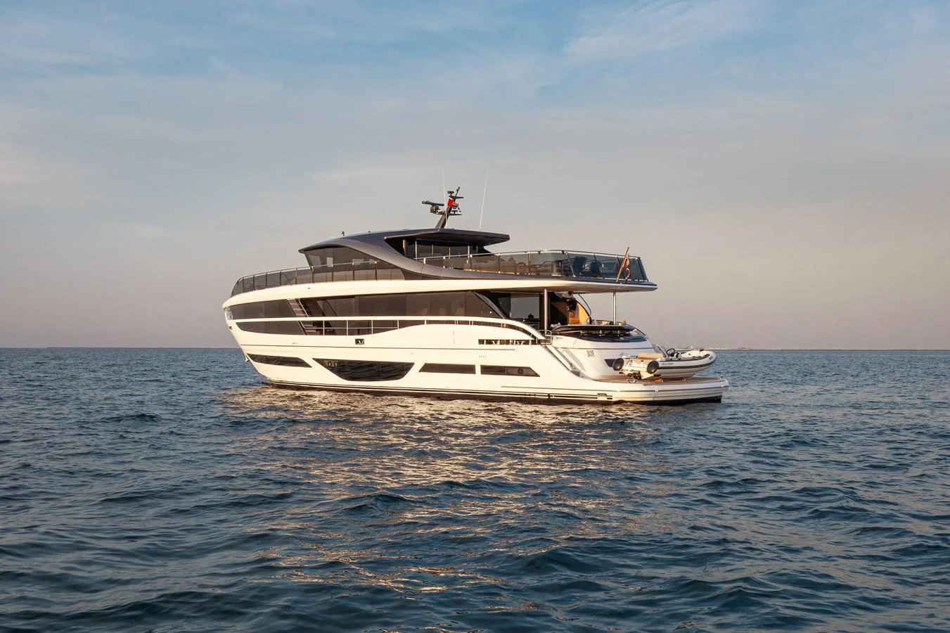 A sleek and modern yacht cruises gracefully on calm waters under a serene sky. aboard PRINCESS X95 808 Yacht for Sale