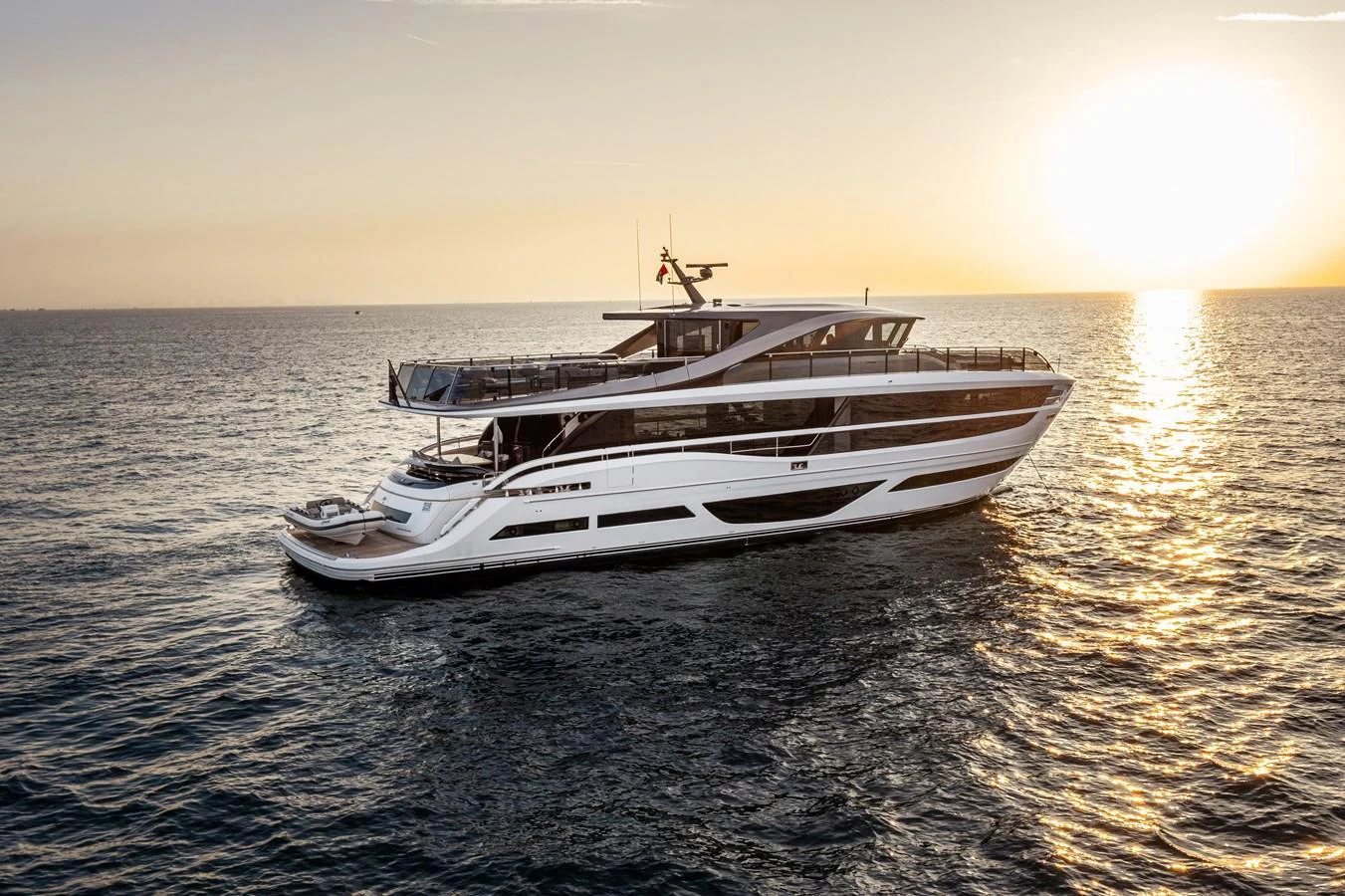A sleek and modern yacht cruising on calm waters at sunset. aboard PRINCESS X95 808 Yacht for Sale