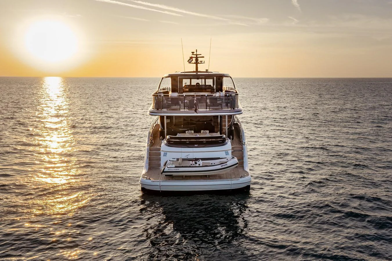 A stunning yacht is showcased against a serene sunset on the open water. aboard PRINCESS X95 808 Yacht for Sale