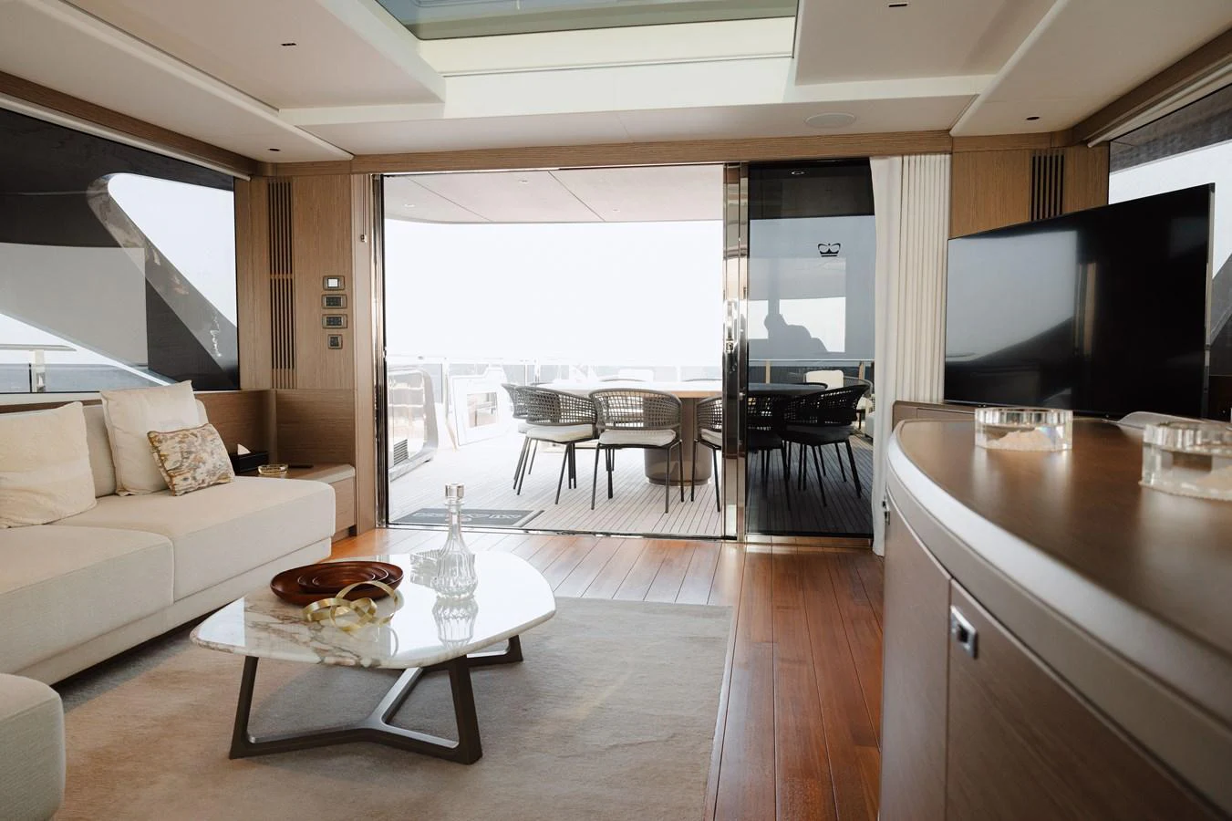 The salon features elegant furnishings and opens to an inviting aft deck with ample seating. aboard PRINCESS X95 808 Yacht for Sale