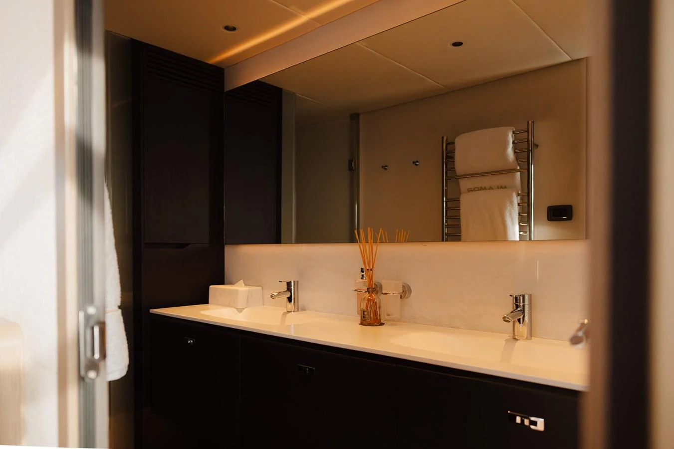 The yacht's bathroom features a sleek design with double sinks and modern fixtures. aboard PRINCESS X95 808 Yacht for Sale