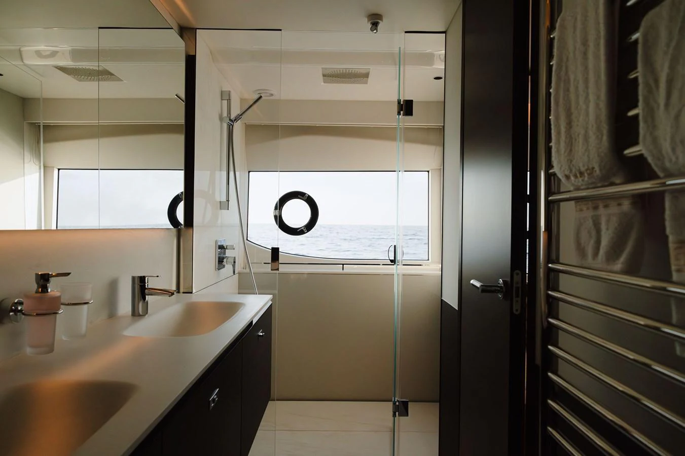 A modern yacht bathroom with a sleek design and ocean view. aboard PRINCESS X95 808 Yacht for Sale
