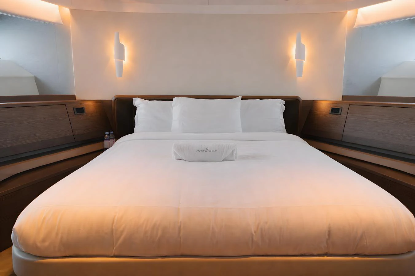 The stateroom features a plush, inviting bed with soft lighting and modern design elements. aboard PRINCESS X95 808 Yacht for Sale