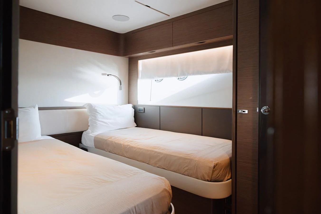 The guest stateroom features twin beds with a modern, minimalist design. aboard PRINCESS X95 808 Yacht for Sale