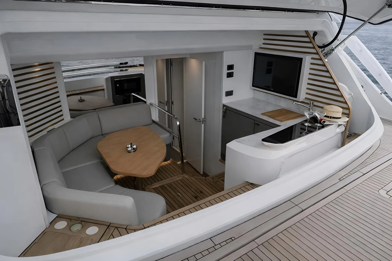 This image showcases a modern galley with a cozy dining area on a luxury yacht. aboard PRINCESS X95 808 Yacht for Sale