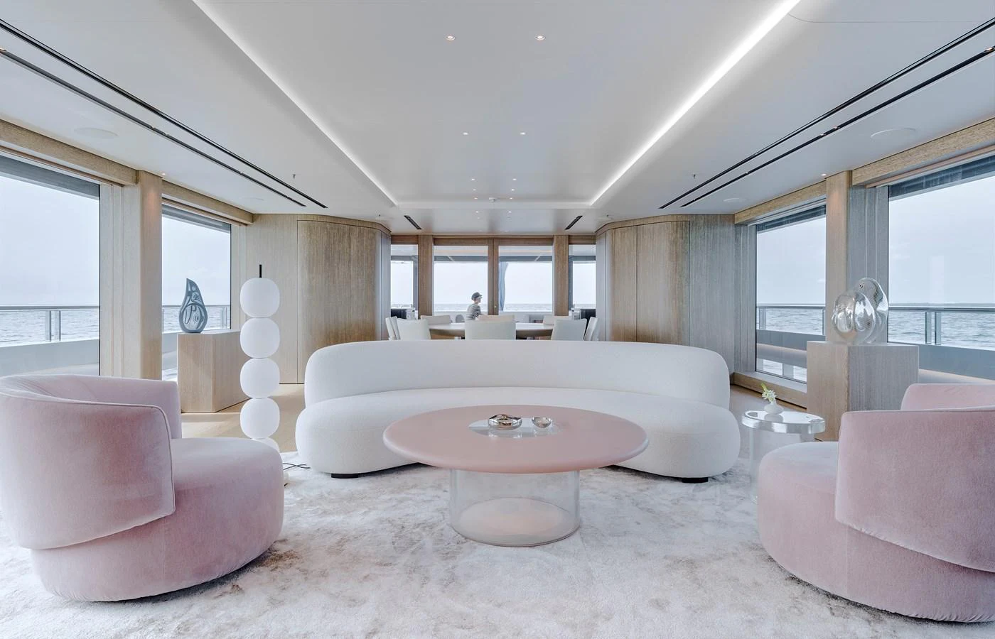 The yacht's salon features a modern and elegant design with plush seating and panoramic windows offering stunning sea views. aboard ENTOURAGE Yacht for Sale
