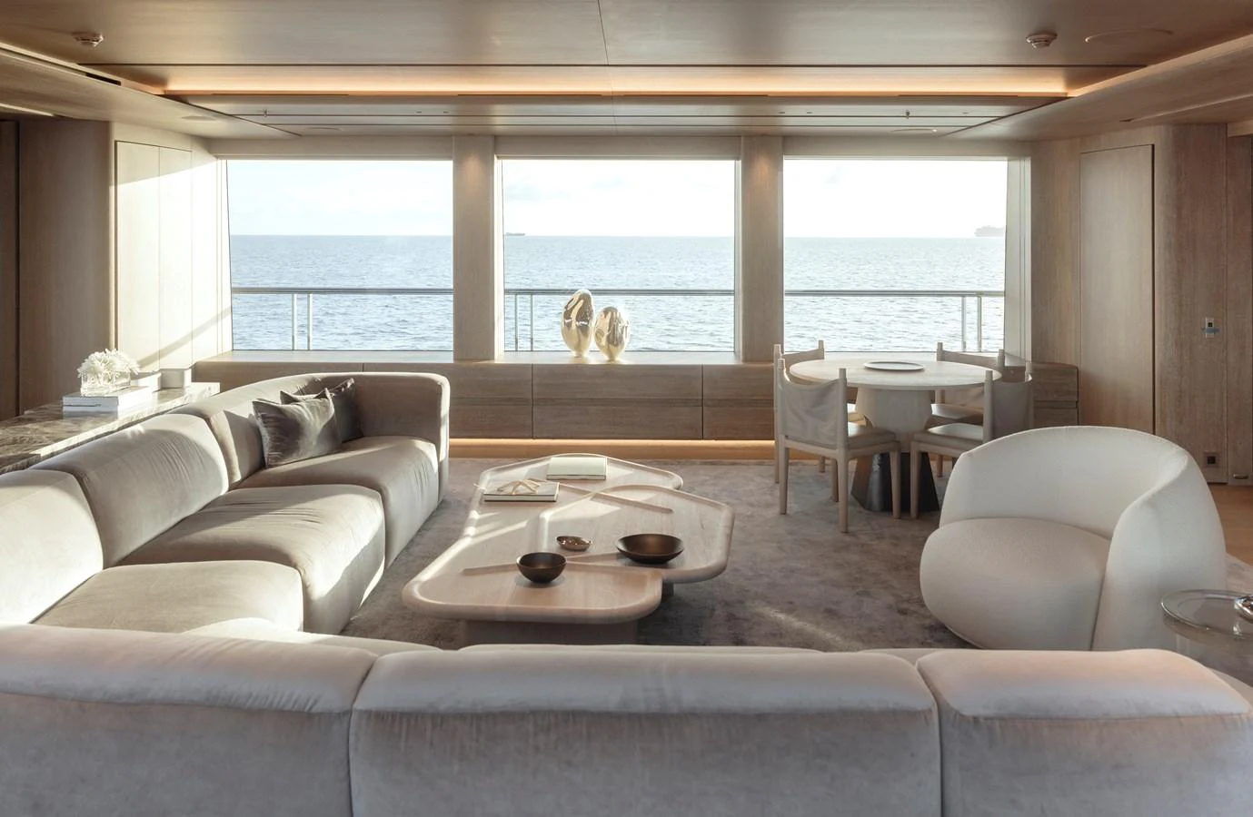 The salon offers a spacious and elegant area with panoramic ocean views. aboard ENTOURAGE Yacht for Sale