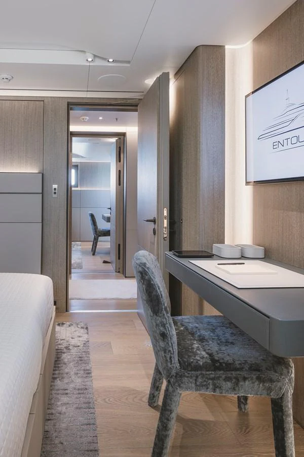 A luxurious stateroom featuring modern furnishings and a sleek design. aboard ENTOURAGE Yacht for Sale