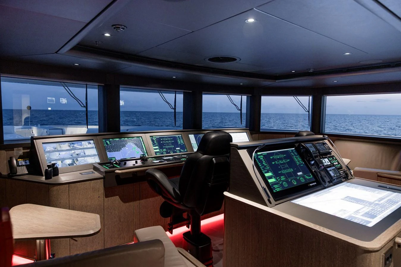 The helm station offers advanced navigation technology with panoramic ocean views. aboard ENTOURAGE Yacht for Sale