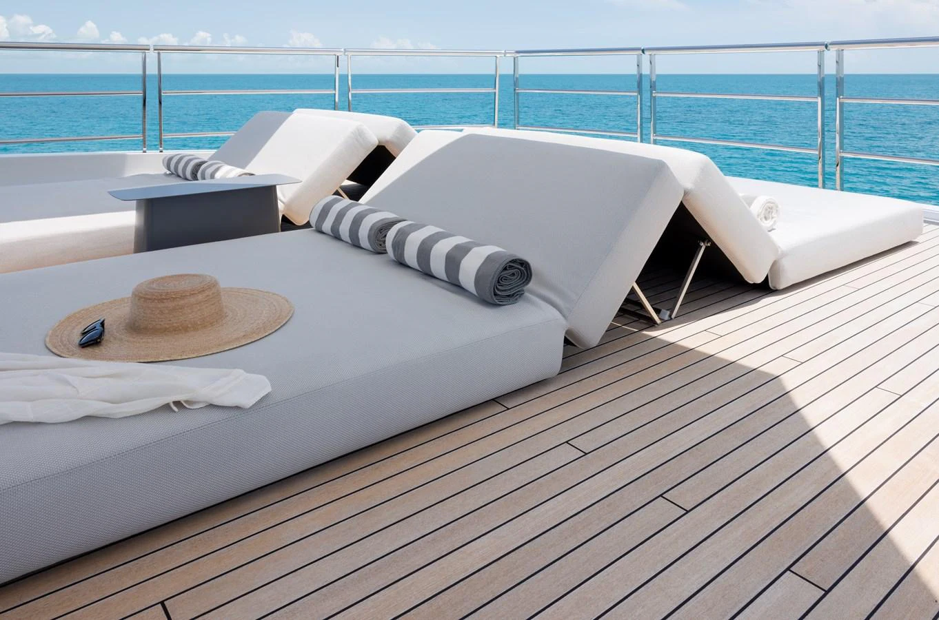 The sundeck features luxurious sun loungers with a stunning ocean view. aboard ENTOURAGE Yacht for Sale