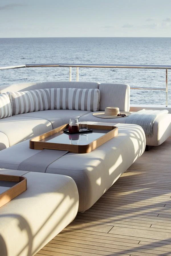 The aft deck features a luxurious seating area with a stunning ocean view. aboard ENTOURAGE Yacht for Sale