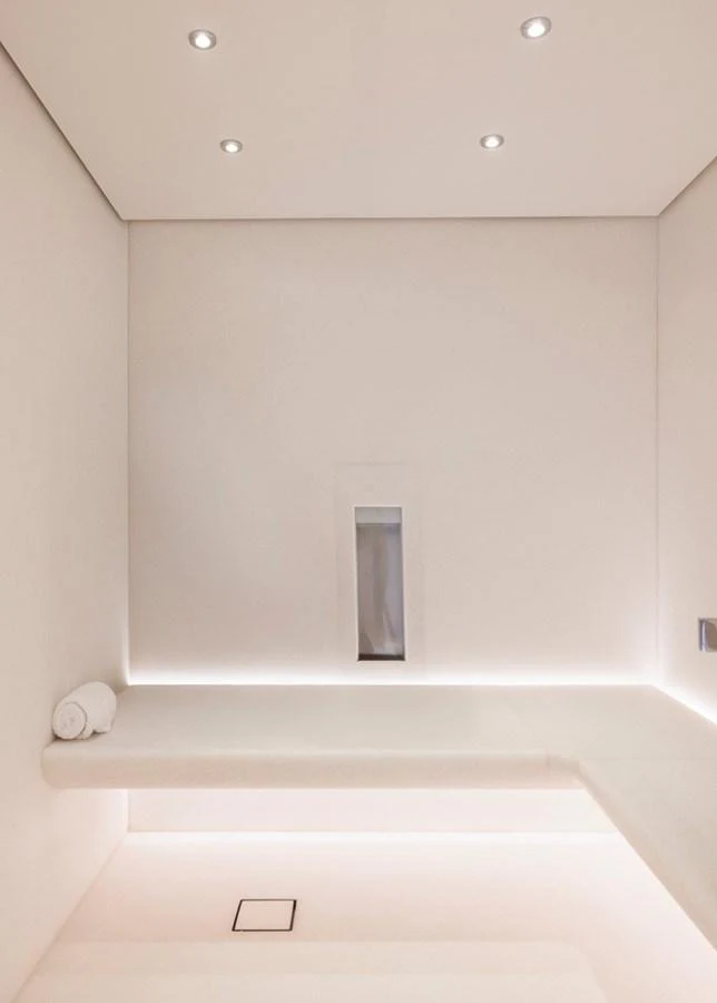 A serene and minimalist interior space with soft lighting and clean lines. aboard ENTOURAGE Yacht for Sale