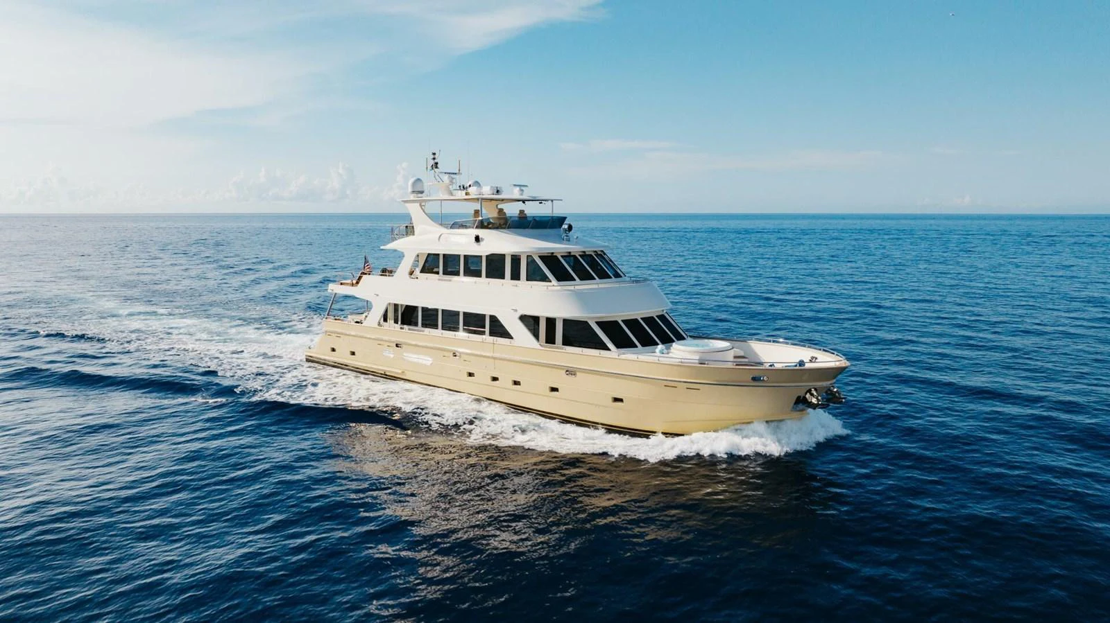 A luxurious yacht cruises through calm blue waters under a clear sky. aboard AURELIA Yacht for Sale