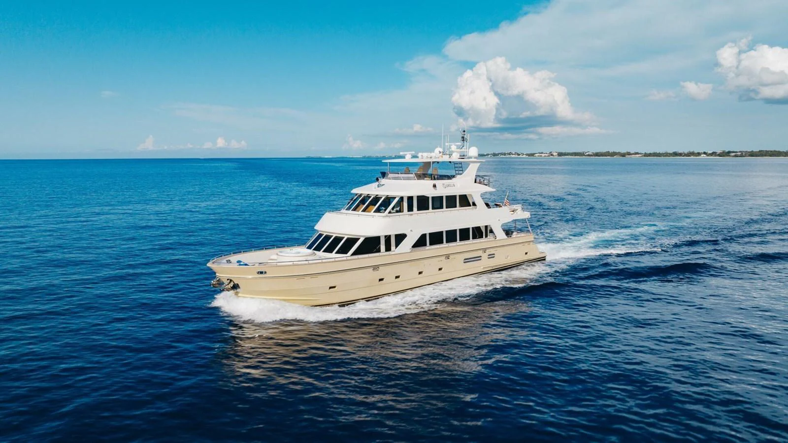 A luxurious yacht cruises through calm blue waters under a clear sky. aboard AURELIA Yacht for Sale