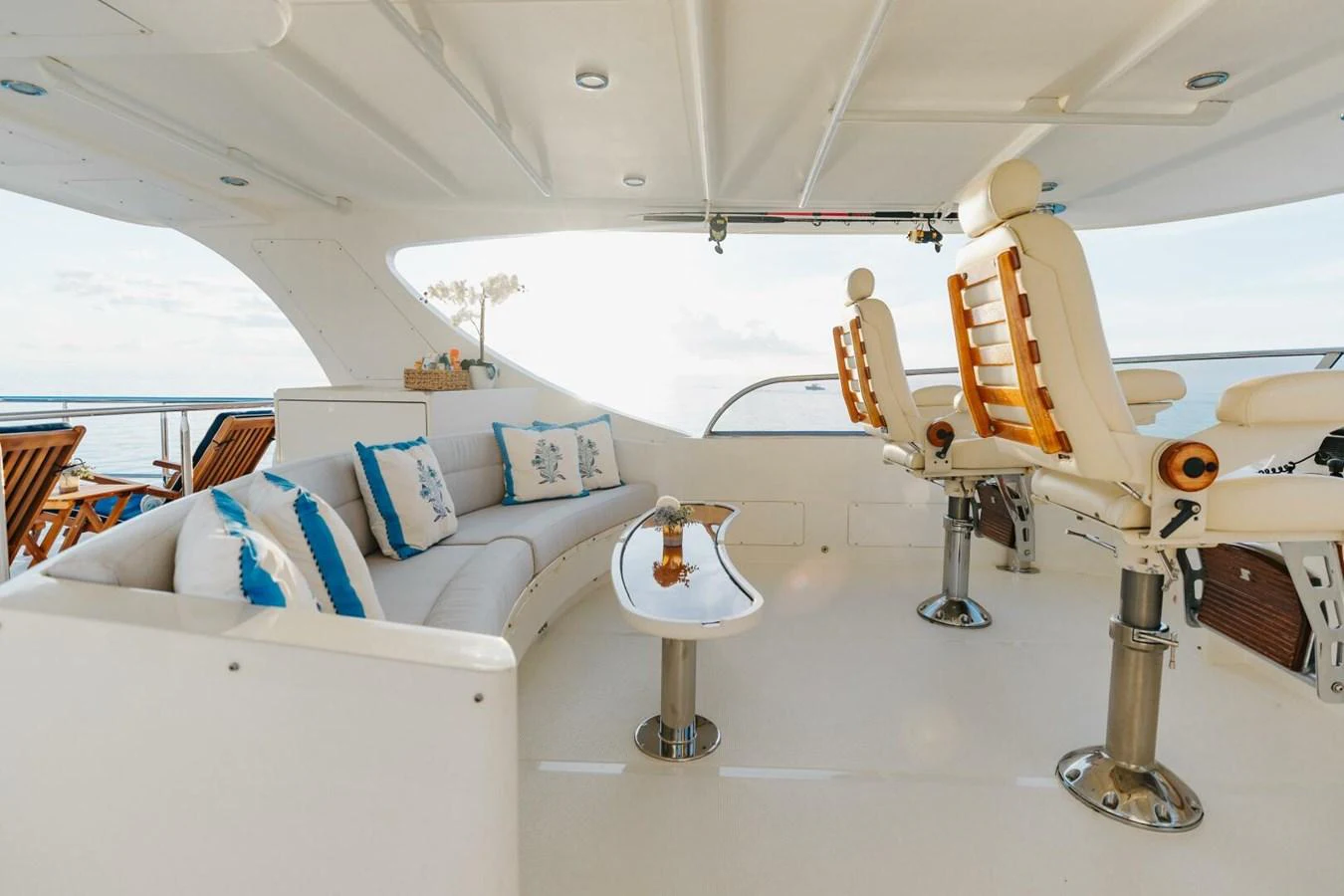The flybridge offers a luxurious seating area with plush cushions and elegant captain's chairs, perfect for enjoying panoramic ocean views. aboard AURELIA Yacht for Sale