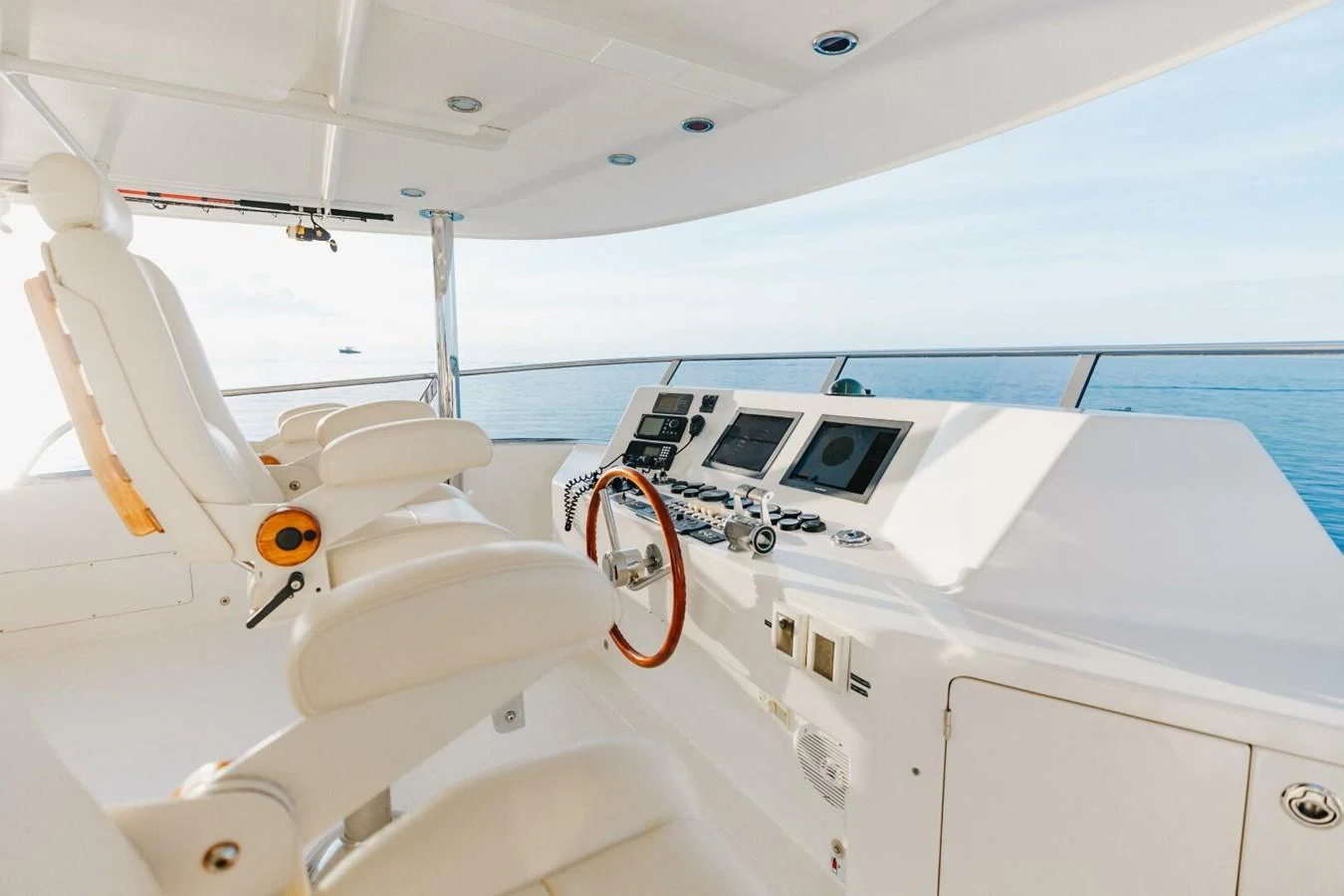 The helm station features luxurious seating and state-of-the-art navigation equipment with a stunning ocean view. aboard AURELIA Yacht for Sale