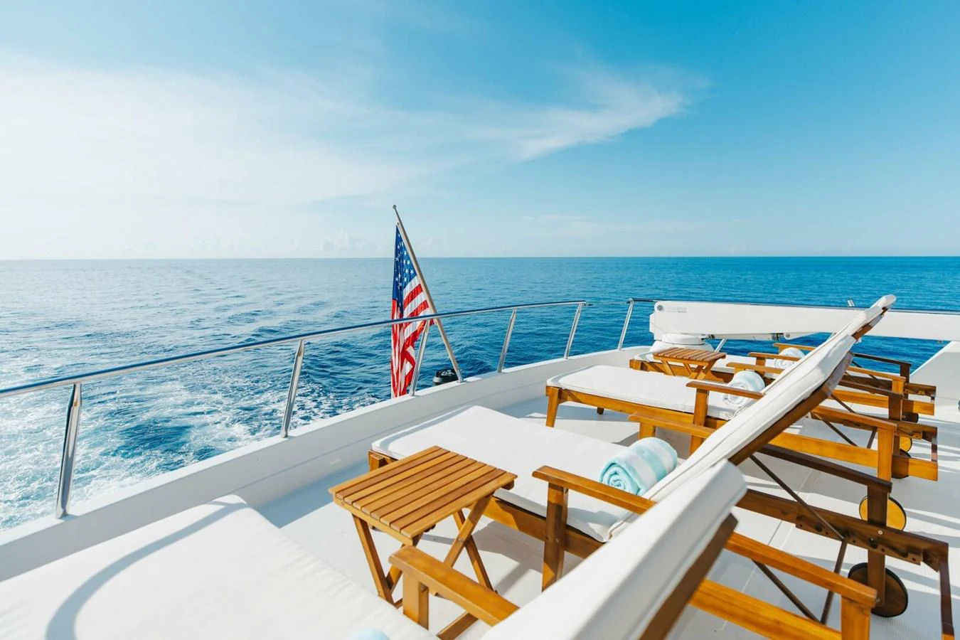 The sundeck offers a serene space with sun loungers and a stunning ocean view. aboard AURELIA Yacht for Sale