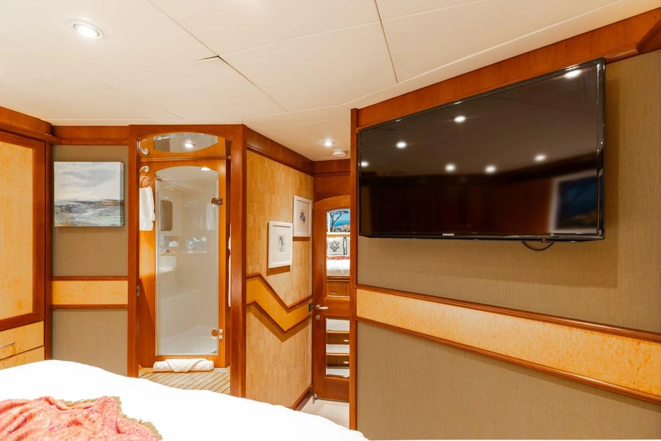 A cozy stateroom featuring a large flat-screen TV and elegant wood paneling. aboard AURELIA Yacht for Sale