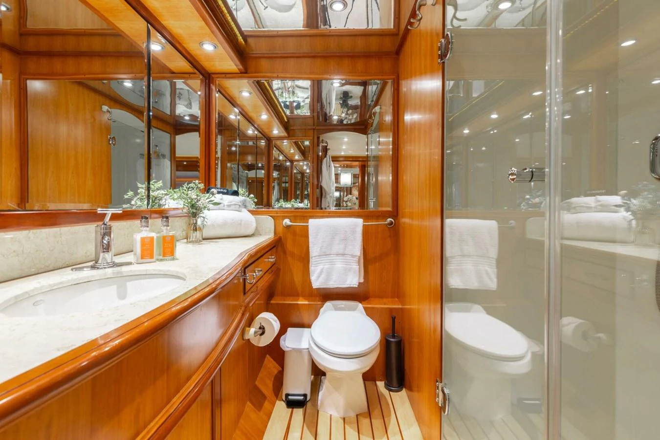 The yacht's bathroom features elegant wood paneling and modern fixtures. aboard AURELIA Yacht for Sale