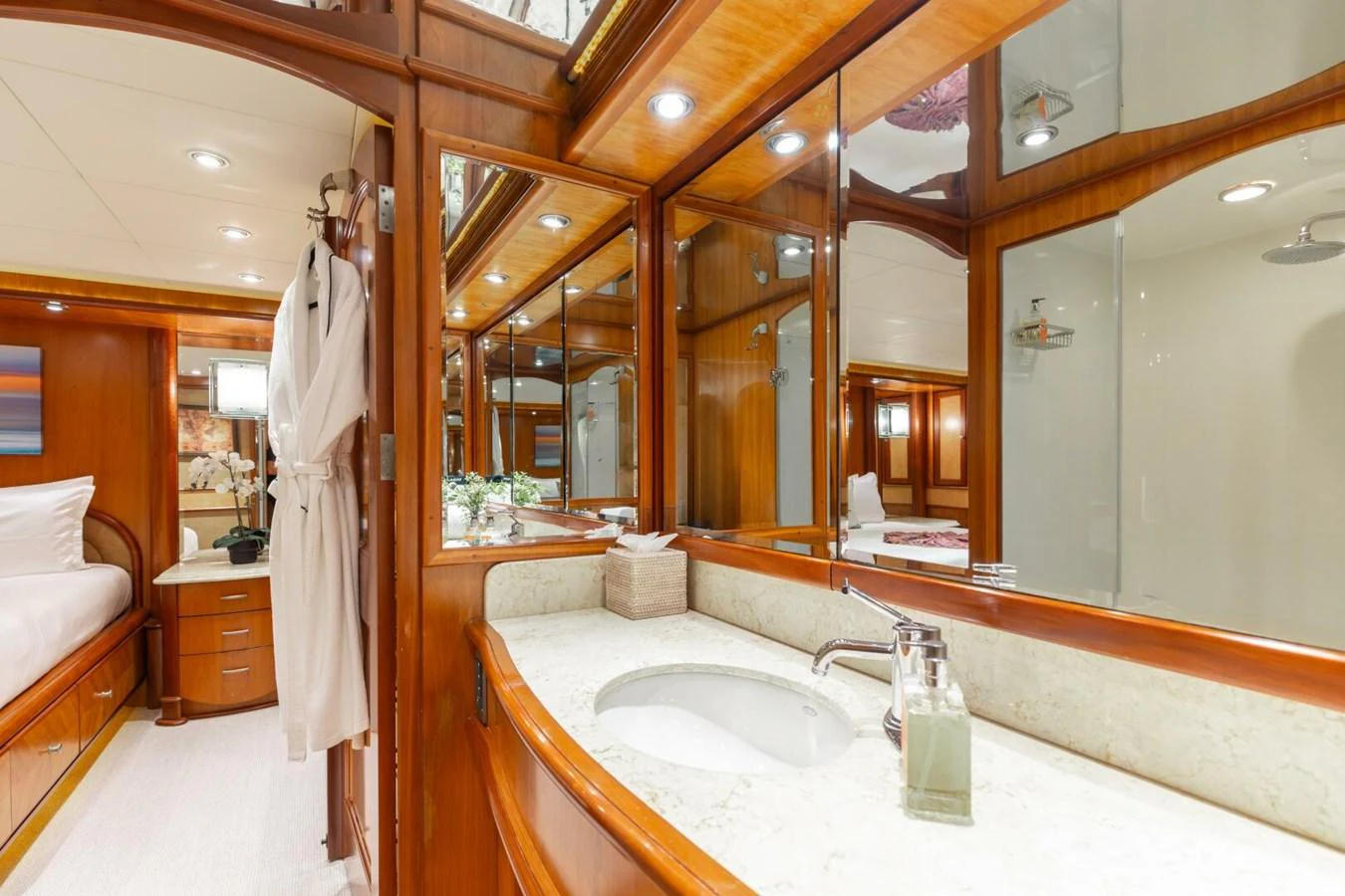 The yacht's bathroom features elegant wood paneling, a spacious vanity, and luxurious amenities. aboard AURELIA Yacht for Sale