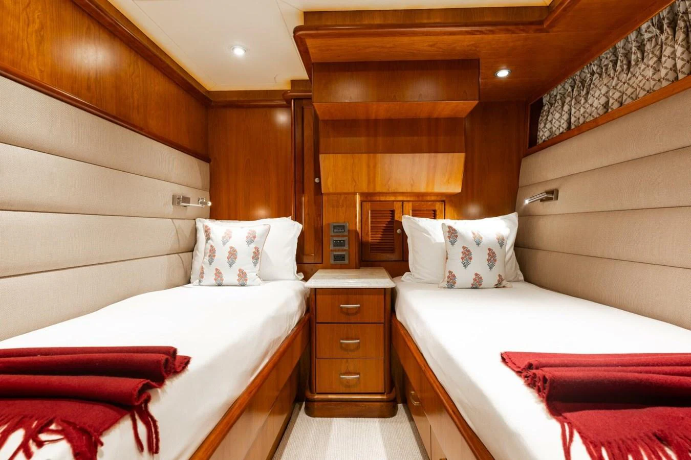 The twin stateroom features two single beds with plush bedding and elegant wooden finishes. aboard AURELIA Yacht for Sale
