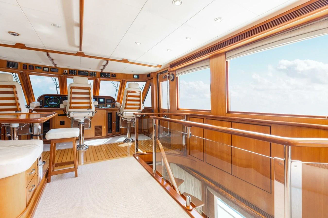 The helm area of the yacht features luxurious wood finishes and expansive windows offering stunning views. aboard AURELIA Yacht for Sale