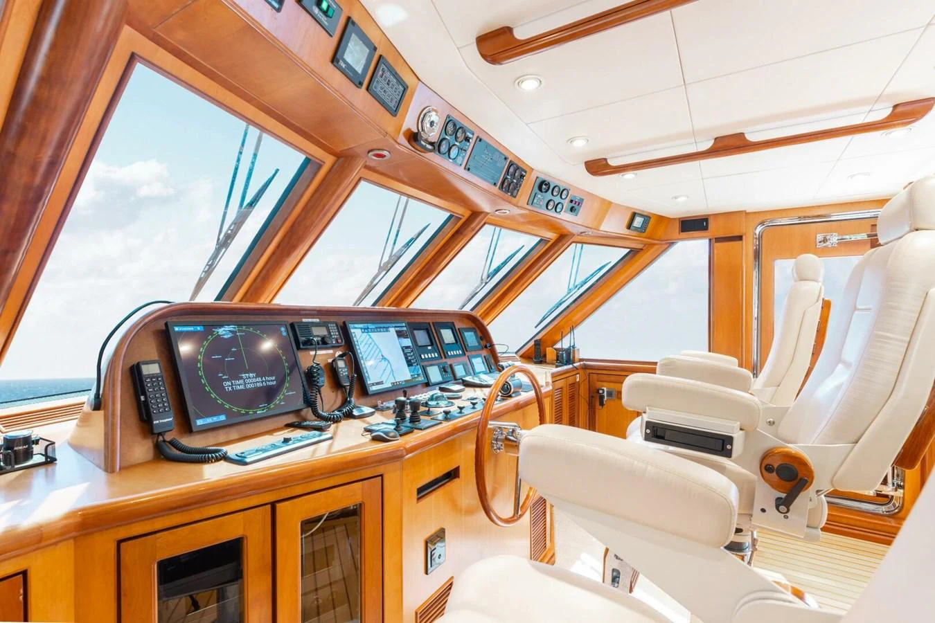 The helm station features advanced navigation equipment and luxurious seating with panoramic views. aboard AURELIA Yacht for Sale
